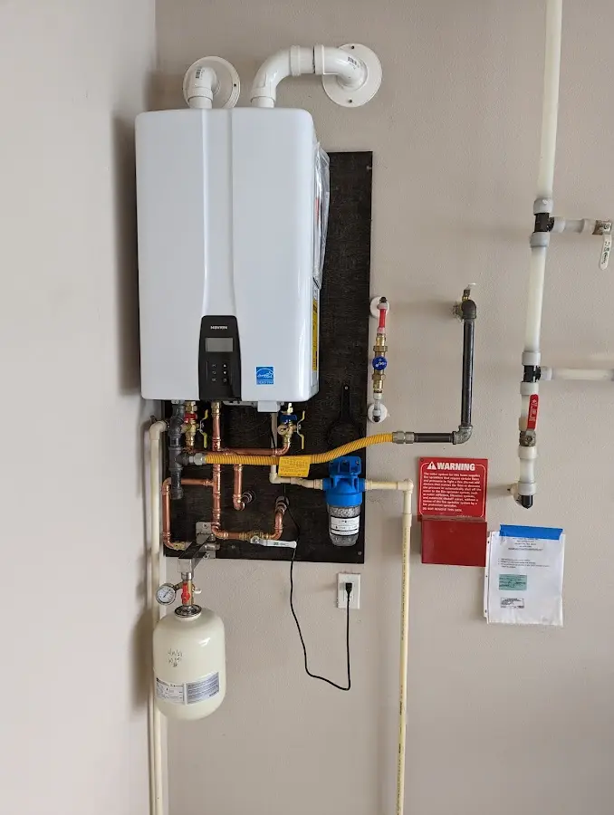 Professional plumber installing copper piping in a Cheshire home